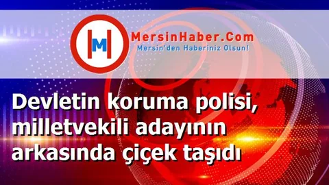 Devletin koruma polisi, milletvekili adayının arkasında çiçek taşıdı